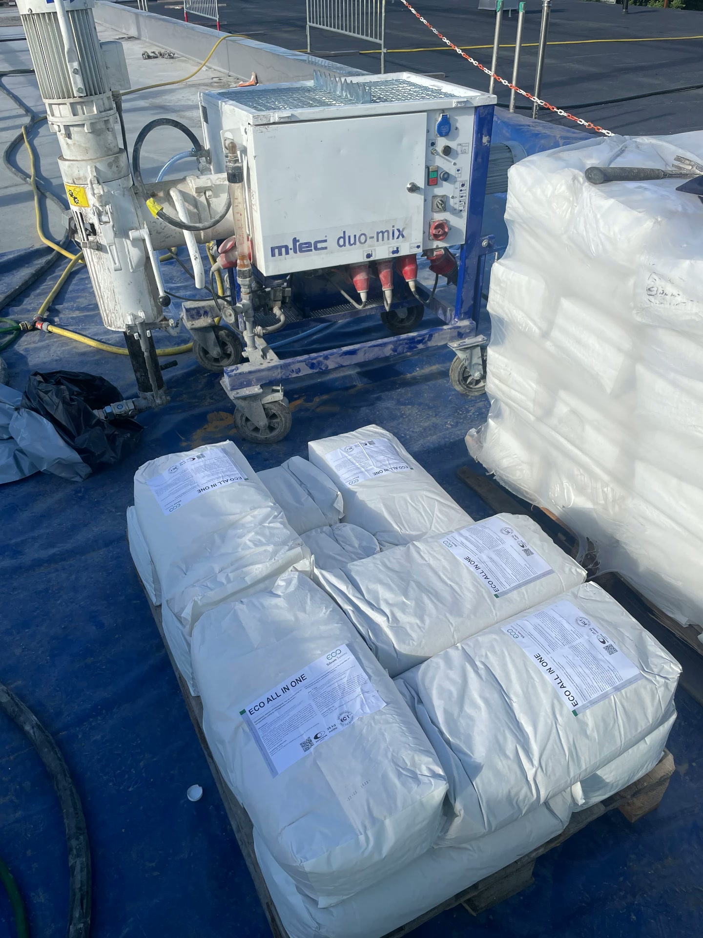 m-tec duo-mix pump and Eco All In One silicate bags staged on a blue tarp at the Kristianstad treatment plant site