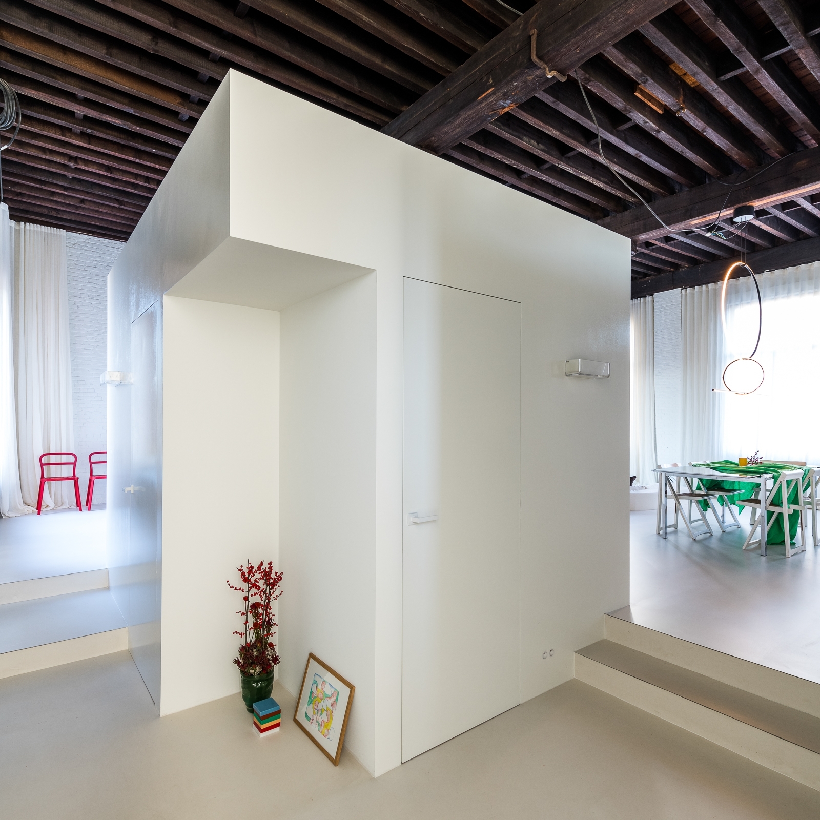 Stepped interior volumes and seamless mineral floor in the renovated Antwerp coffee-roasting factory
