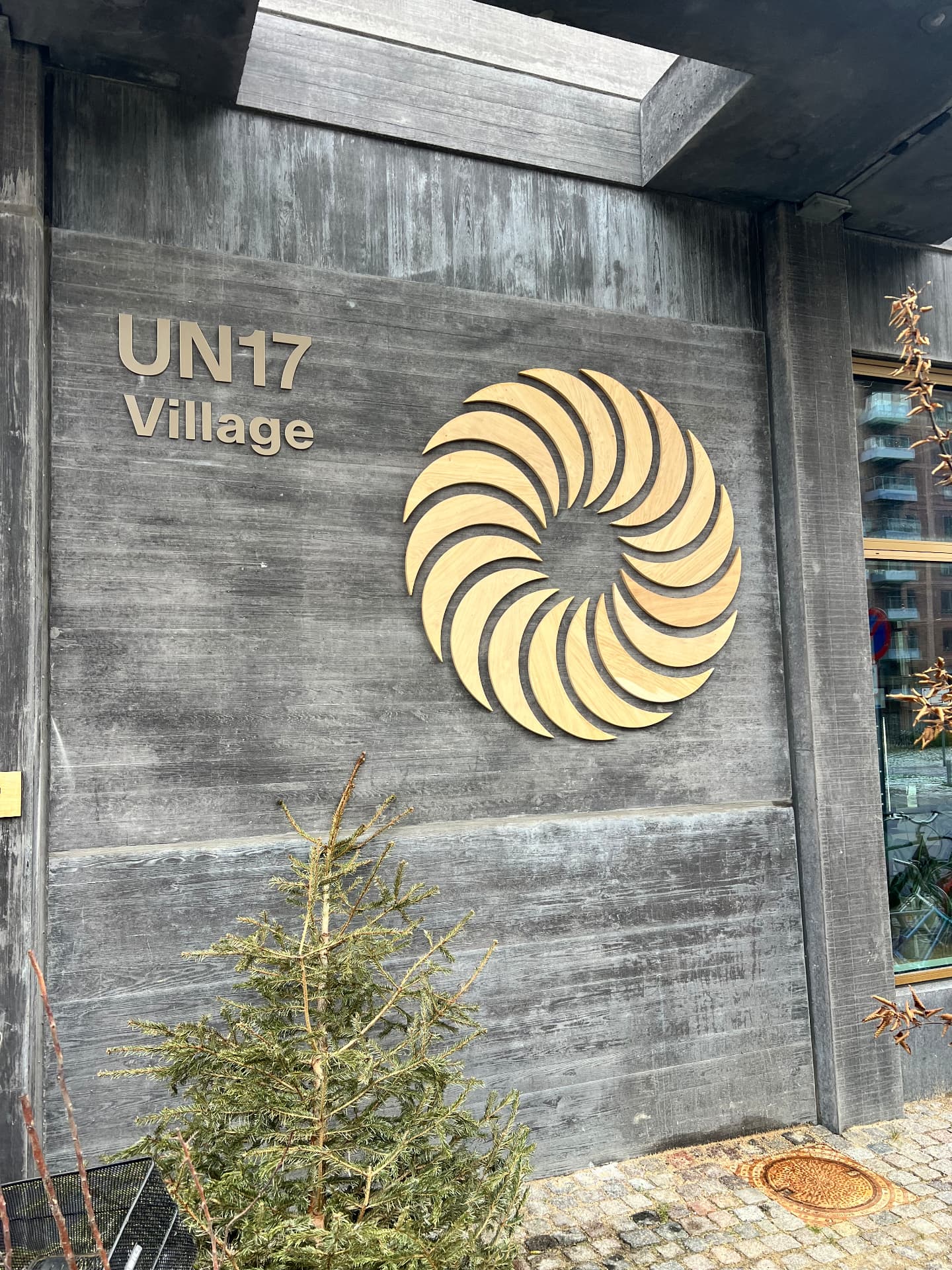 UN17 Village signage and logo on the board-marked concrete façade in Ørestad, Copenhagen